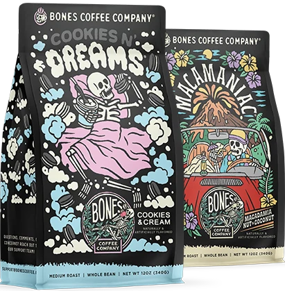 Two 12 ounce bags of Bones Coffee Company coffee. From left to right their names are Cookies N' Dreams and Macamaniac.