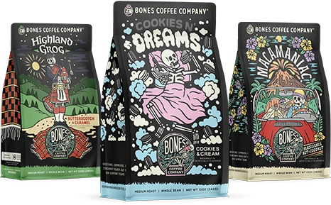 Three 12 ounce bags of Bones Coffee Company coffee. From left to right their names are Highland Grog, Cookies N’ Dreams, and Macamaniac.